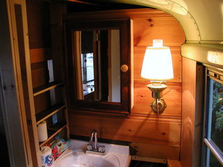 medicine cabinet and sconce lamp in bathroom